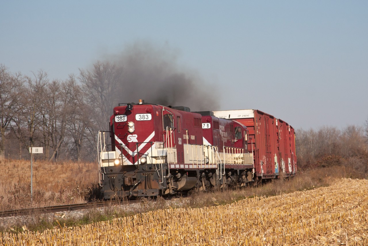 Ontario Southland 383 & 378 throttle up for the trip to St. Thomas. Rather long train today for St. Thomas, I never counted but it was well over a dozen cars. Passing my family home @ Mile 11 during my trip home this week.