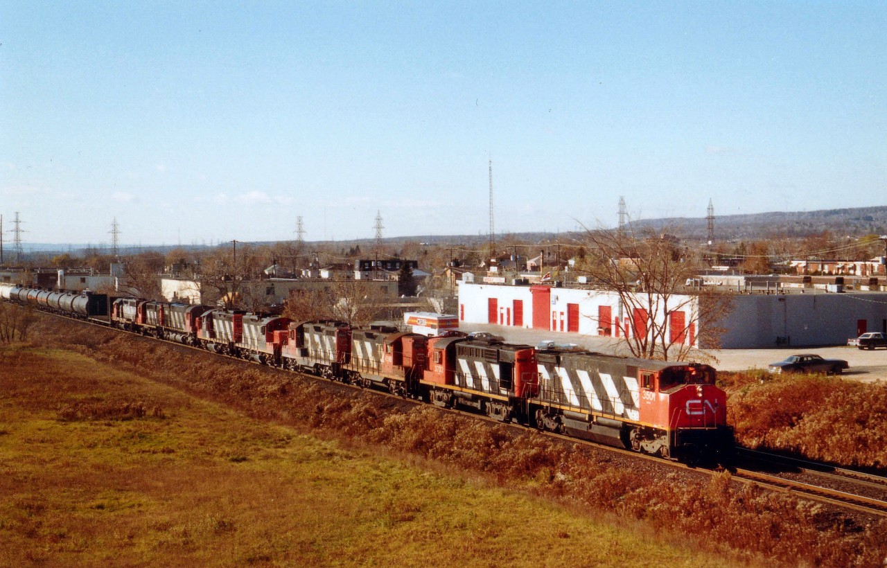 With a collection of power almost bordering ridiculous, #432, Niagara to Mac Yard, (if I recall correctly) is seen here approaching the Mainway area of Burlington with CN 3501, 3702, 4590, 4520, 4116, 4105, 2333, 3744 and 9303 and what I recall a 60-70 car train. Short, by today's standards. I'm thinking every model featured on this train is no longer on the current CN roster.....