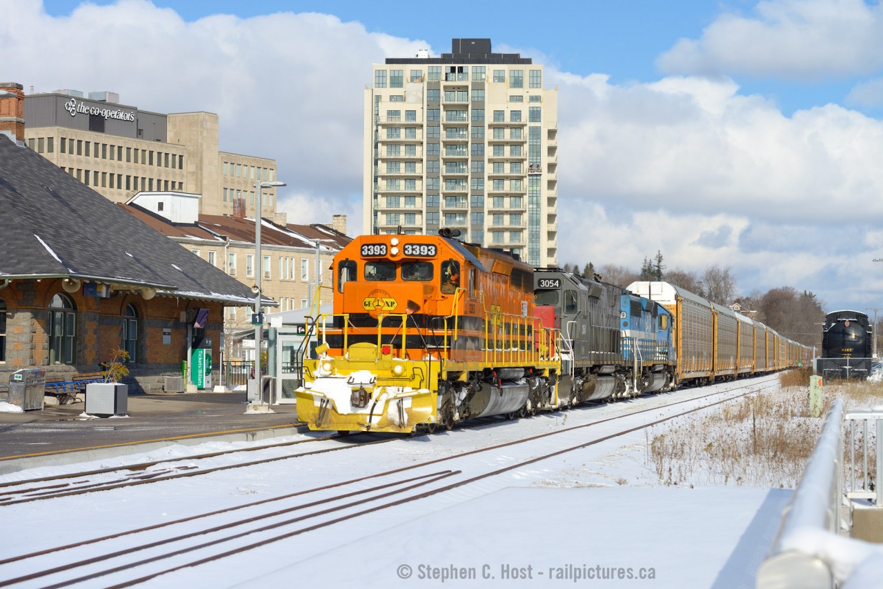 As Bob Dylan sang "And the times they are a changin'". At Guelph, Genesee & Wyoming orange graces the presence of the point of Train 431 - passing by the 1911 Grand Trunk built station. GO has installed elevators, stairs, a tunnel and a platform on the north side. The South platform is roughed in but won't be installed for a while yet. And of course who can miss the new Condominium - look close and a pair of workers are acending the right side windows working on this cold winter-like day. Lastly, CNR 6167's tender is seen at right. In 2010 this scene looked far far different.