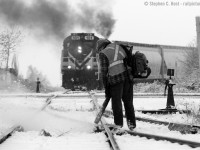 Winter's here - atypically early for this part of Southern Ontario - and snow fighting has already begun. A whoosh of snow is exiting the right of way thanks to a gas powered leaf blower operated by one of OSR's track maintainers, and a whoosh of MLW diesel exhaust exits OSRX 181 as Job 1 shoves cars up grade into PDI's new Massey Rd facility in Guelph. 