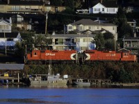 CP locomotive 3000 rolling past homes on the north side of Delta along the Fraser River east of the Alex Fraser Bridge by one city block.