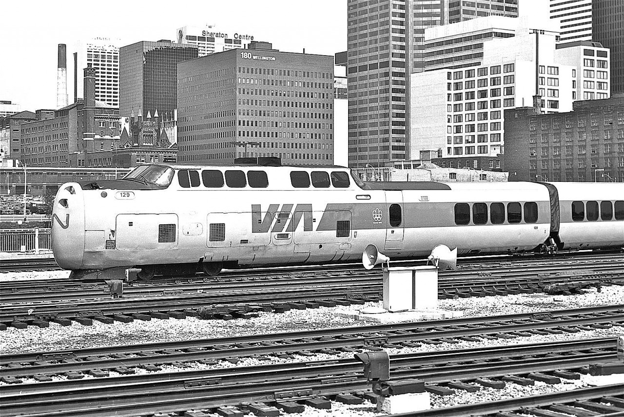 As I prepared to post this image, I did a little bit of internet research.  It is amazing how much there is to learn about the Turbotrain…


-  The train was designed by the United Aircraft Corporation


-  It was one of the first gas turbine powered trains to enter passenger service


-  It was one of the first “tilting trains”.  This prevented the passengers from being pinned against the walls due to centrifugal forces during travel on curved, high speed segments of track


-  The trains were built by the Montreal Locomotive Works

 
-  The power source was the modified PT-6 turbine engine (world famous in the aviation industry) manufactured by Pratt and Whitney Canada, in Longueuil, Quebec


-  CN hoped to introduce the new train for EXPO ’67, but missed the deadline

  
-  It was designed to operate on the high speed corridor between Toronto and Montreal


-  The Turbotrain set a Canadian speed record on April 22, 1976, when it reached a speed of 140.5 mph, near Gananoque


-  Demonstration runs began in 1968.  The Turbo’s final trip was on October 31, 1982


During the Turbo’s history, it had a number of famous mishaps including fire and collisions.  CN reports that during the train’s history it had a reliability rate of over 97%.  I believe this is a real tribute to those that designed, built, maintained and operated this revolutionary piece of equipment.


I took this photograph at Toronto’s Union Station, circa 1976.  Black and white is cool, but this is one shot I wish I had recorded in colour.  As a young man, it was my dream to ride the Turbotrain… sadly, that dream was never realized.  Gone, but not forgotten…