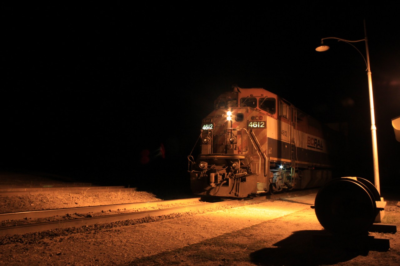 Boo! This BC Rail unit leads an oil train as a fresh crew waits for a clear signal out of Rivers on a spooky Halloween night.