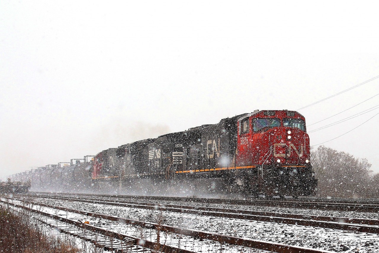 As the conditions got worse the eastbound led by CN 5675, NS 8413 and CN 5427 fought it's way through the snow.