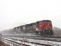 As the conditions got worse the eastbound led by CN 5675, NS 8413 and CN 5427 fought it's way through the snow.