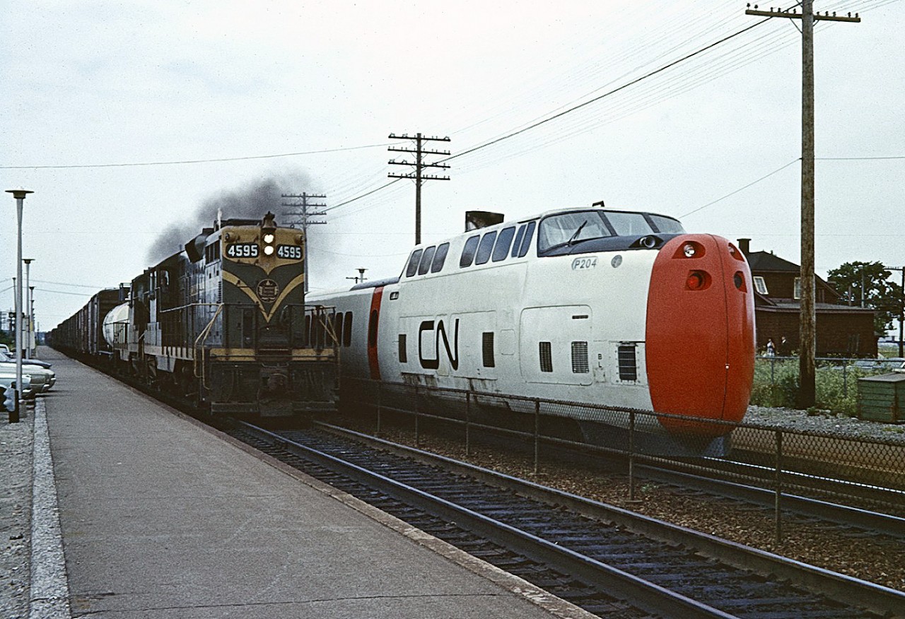 The time is 18:26, and CN 69 has just arrived at Dorval.  P204 is the tail-end power car for 69's Montreal to Toronto 3 hour 59 minute run.  
As 69 takes on passengers at its only westbound stop, the locomotive engineer on CN Extra 4595 East notches out the throttle for the final few miles to CN's Taschereau Yard.