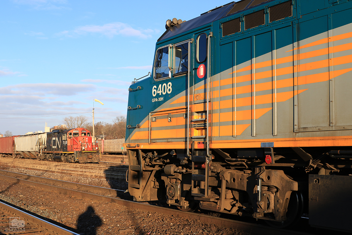 With 5 cars in tow CN 580 patiently waits for its shot out of the yard as VIIA train 71 departs Brantford.