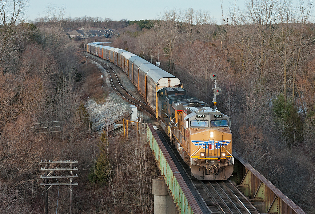 With very little light left in the afternoon, CP 147 rumbles through Woodstock with a UP ES44AC leading the way.
