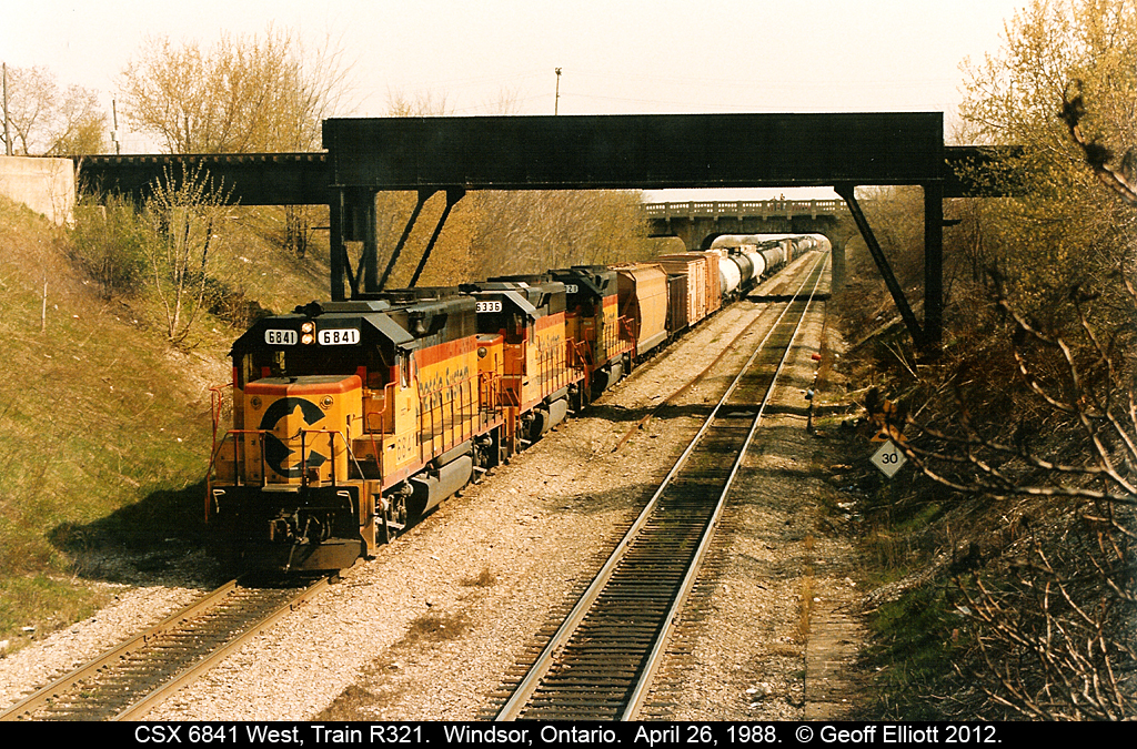 "Down the Tubes"....  CSX 6841 leads two of it's Chessie sisters down the grade toward the Windsor/Detroit Railway Tunnel where they will pass under the Detroit River and emerge on U.S. soil.  The train's tail end is still at the top of the hill next to the old Windsor South Depot and the head end is passing under both the College Ave. and the Essex Terminal Railway bridges in this photo.