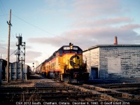 CSX 2012, and a former Chessie sister, arrive in Chatham from Sarnia late in the day on December 8, 1990.  2012 is just about to hit the CN Chatham Subdivision diamond as it passes between the old Chatham Enginehouse and Sanding tower.  Sadly all that is left of this scene is a single diamond, after CN/VIA single tracked the Chatham sub from Bloomfield east, and a quiet section of the CSX that goes as far as the CP interchange.  Once CN 'leased' the property all the structures were demolished within a few weeks.  Thanks CN.....  You suck!!