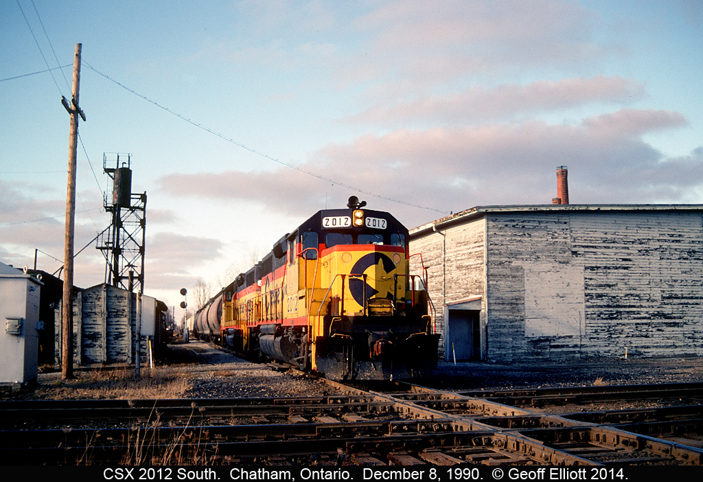 CSX 2012, and a former Chessie sister, arrive in Chatham from Sarnia late in the day on December 8, 1990.  2012 is just about to hit the CN Chatham Subdivision diamond as it passes between the old Chatham Enginehouse and Sanding tower.  Sadly all that is left of this scene is a single diamond, after CN/VIA single tracked the Chatham sub from Bloomfield east, and a quiet section of the CSX that goes as far as the CP interchange.  Once CN 'leased' the property all the structures were demolished within a few weeks.  Thanks CN.....  You suck!!