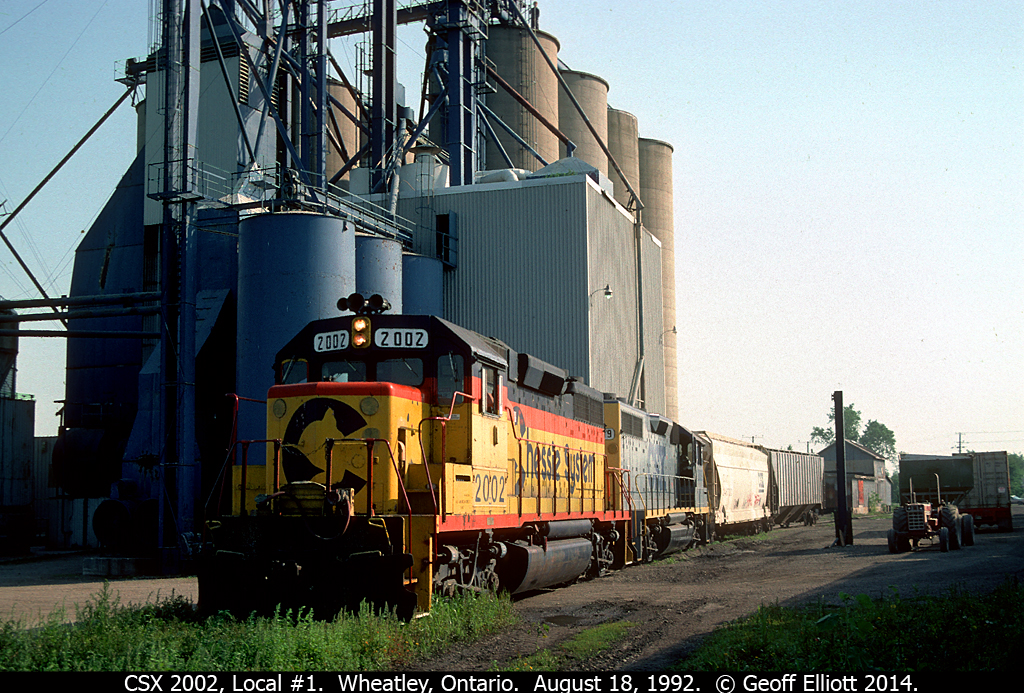 On a hot August morning back in 1992 I received a call from my Grandmother in Coatsworth that the train went by her house and was heading for Wheatley.  I high-tailed it to Wheatley and waited for the local to show up.  With CSX (Chessie) 2002 on point we have the local spotting 2 cars into the Wheatley Elevators facility.  On top of the mill we have an on-looker who is surely wondering WTH I'm doing, but no matter.  I followed 2002 as it shoved it's train from Wheatley back to Blenheim, having to give up the chase in Merlin as I had to head to work.