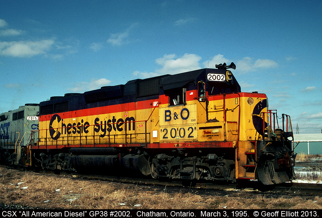 CSX 2002 is teamed up with CSX grey GP38 #2015 as they rest on the southeast connection to the CP yard in Chatham, Ontario.  At this time you can see that the CSX shops had re-applied the "B&O" on the cab if you compare this shot to the one taken in March of 1994.  Also of note is the white square on the step guard behind the cab which states, "DO NOT DISMANTLE.  On Release from service hold for shipment to the B&O Museum via Locust Point, Baltimore.  Contact Museum at (410) 752-2388 or J.H. Horvatter Jr. CSXT JAX Ext. 1883".  Funny that this instruction wasn't followed as 2002 became CSX MOW Pumpkin 9699 and was nearly sold off until someone caught the mistake and got the unit transferred to the museum.  Thankfully you can now go see here in all her former beauty as B&O 3802 again at the B&O Museum.