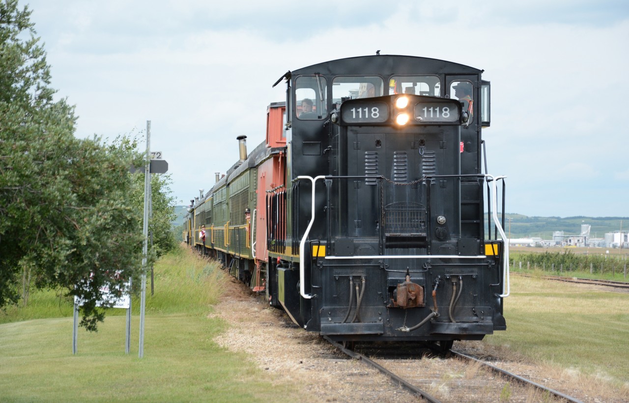 Led by Alberta Prairie's 1118, a GMD1m, the day's train pulls into the station at Big Valley. 1118 was originally a CN unit, then to Canadian Railserve in 1997, Central Western Railway in 5/1998, and finally Alberta Prairie.