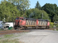 CN 2402 and CN 2420 are the power for a training train back in September 2009. Note that the gates of the level crossing are not all the way down, even though the power is over the road.