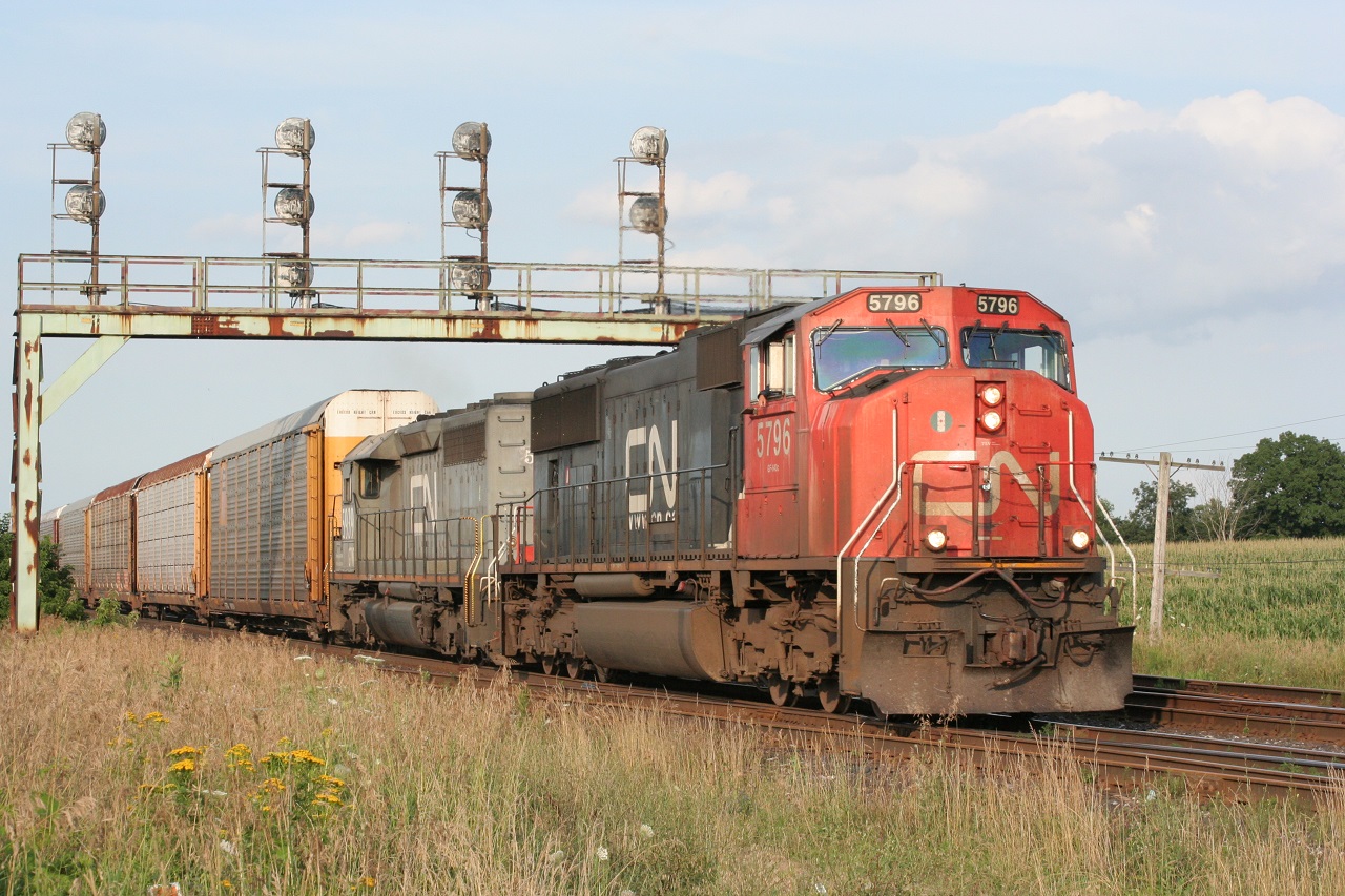 CN 5796 and GTW 59xx break the silence of a summer evening as they hustle westwards with their freight.