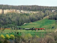 Classic A-B first generation diesel power in freight service: 25-year old unrebuilt CP FP7 4031 and F7B 4433, in charge of a westbound extra, are stalled climbing the grade up the Niagara Escarpment near Mile 35 of the Galt Subdivision. In the background, the Kelso Conservation Area ski hill looms apparent, with the conservation area's pond in the foreground, and The King's Highway 401 in front of the photographer but not visible.<br><br>Eventually the train would get on the move again, captured <a href=http://www.railpictures.ca/?attachment_id=16118><b>here rolling through Campbellville near Guelph Junction</b></a>.
