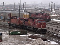 After pulling their train in on F11, 420 with SOO6053-CN2145-3070 cut off and headed over to the shop tracks, but was told to wait for permission. While they waited, 2-420 with 9157-5833 cut off their 1,900' train on F12, and pulled up to the east end to enter the shops behind 420's power.