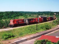 CP 8791 and 8737 with a work train drifting down the grade from Waterdown en route to Aberdeen Yd in West Hamilton. The track in the foreground is known as "CN Cowpath" and the building in the lower corner, at the time MoW storage and now is long gone, was once the site of a Grand Trunk passenger station.