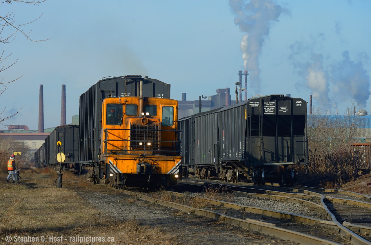 Deep in the north end of industrial Hamilton - at the end of Parkdale Ave N. lies a small yard called Strathearne by SOR. Rich in history and quite busy - sometimes you get lucky. This was the second time in four years  I've found Columbian Carbon switching with their March 1957 built GE 45 Tonner. The crew is seen switching cars in the Strathearne yard and the engine is on the Strathearne yard mainline. 
Four train operators use this track - in recent weeks both SOR and CP can be found switching customers here - behind me is A&M Metals who also acquired a trackmobile for the sprawling metals recycler. Add in Columbian and that's up to four operators in a very small section of track. How about the history? From what I can tell - this track is actually the last remaining segment of the Hamilton Radial Electric Railway which ran along the Beach Strip to Burlington and was abandoned in 1929.