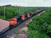 Quebec Cartier Mining empty ore car train heading north just out of Port Cartier with this classic MLW M-636 lashup of 87, 75 and 76. These units are gone now, 87 (former CN 2331) scrapped 2011, 76 sold to a scrapper same year, and 75 now toils on the WNY&P as #638. And the railroad is known now as Arcelor-Mittal Mines Canada, and no longer has any MLWs on the roster. That is the St. Lawrence River in the far background.
