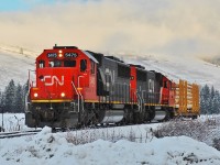 CN nos.5475 & 5441 have picked up a single pole car in Lumby and are approaching Lavington where it will be added to a train load of lumber that is destined for Kamloops later in the day.
