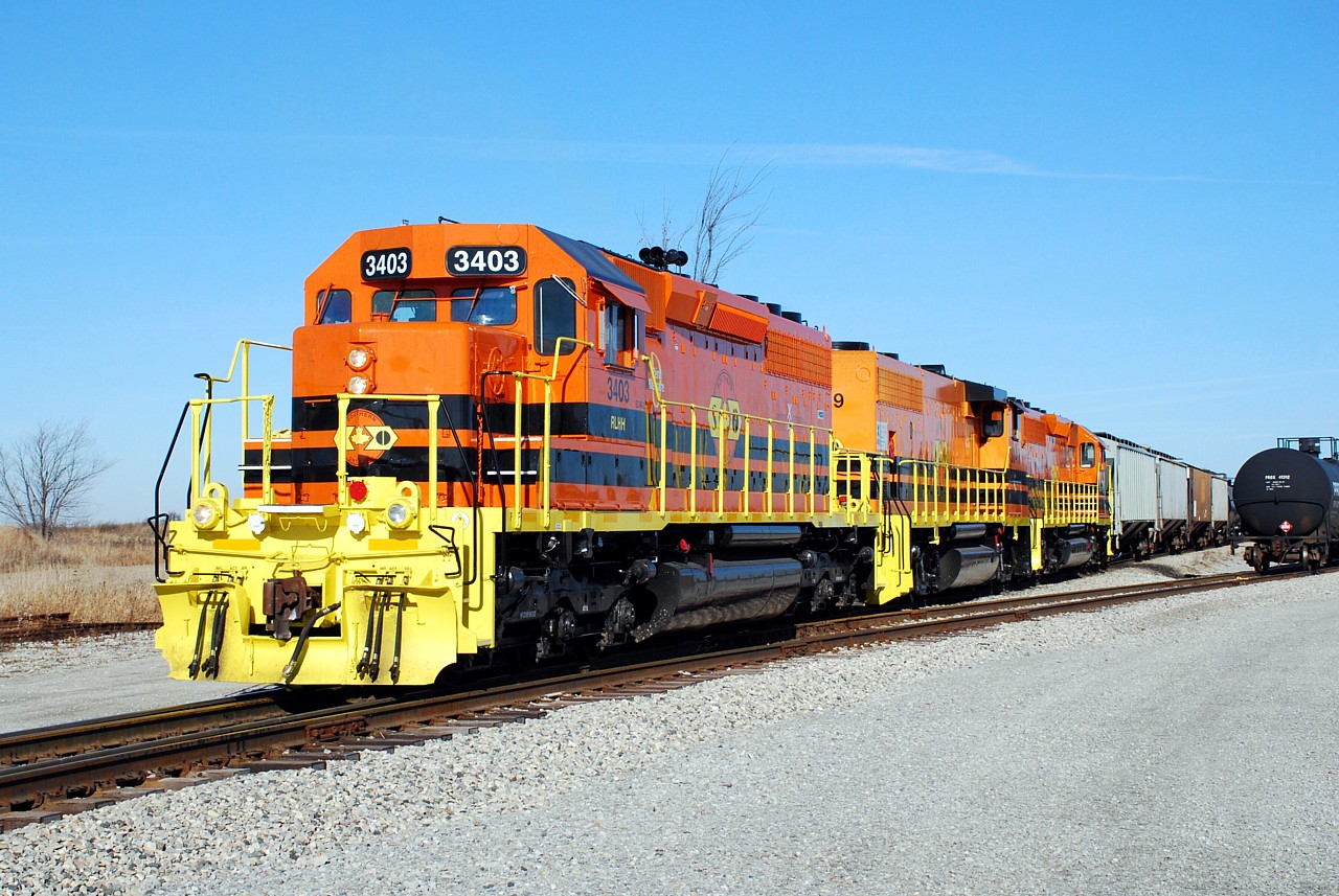 RLHH 595 with RLHH 3403, 3049 & 3404 start their day by switching out 596's train that arrived earlier in the morning from CN in Brantford. The bright late-fall sun really shows the difference in orange paint applied to 3403 (at NRE in Paducah, KY) and 3049 (at LDS in Sarnia).