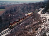 A miserable typical December day, but I finally, after many attempts was able to catch a train heading northward into Hamilton at the Dewitt Rd crossing in Stoney Creek. For some reason unknown to me the hillside was undergoing a brush-cutting, which provided a rare opportunity here. Followers of RP will notice how many photos of TH&B there are out there, but how FEW of them feature northward moves. Darn hard to catch. On this dark afternoon, TH&B 401, 402 and 77 is the power seen downbound. This area now is rather built up, huge homes crowded in a modern subdivision of the people kind, and still, Dewitt Rd is a steep climb, one way upward.