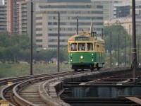 The Edmonton Radial Railway Society's 930, an originally Australian tram built in 1946, comes south on the High Level Bridge on an evening during the Fringe Festival. It might appear there is excess space on the bridge deck to the sides of the track, and originally there were indeed tracks to either side of this central track, which were used by streetcars. CP ran trains along this central track until 1989. The tram in this photo, 930, has now been moved to the society's operations at Fort Edmonton Park.