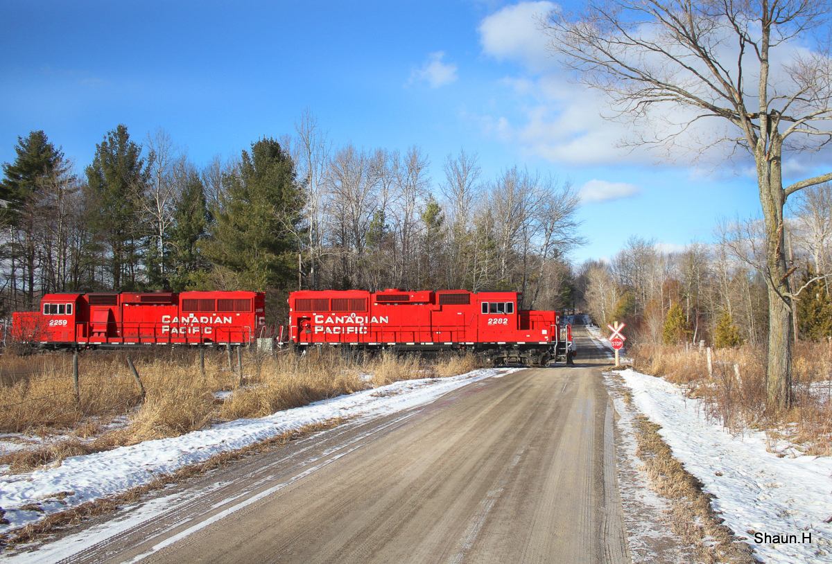 CP T08 with 3 GP20Eco units crosses a rural road just east of Pontypool, T08 is on its way to Havelock yard with a cut of empty hoppers for the mines in Nephton.