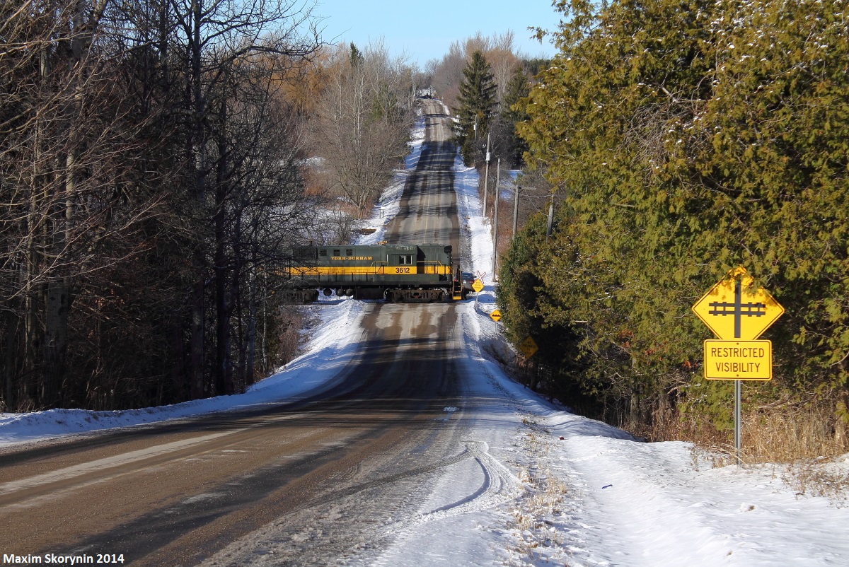ALCO RS-11 3612 is in charge of the Santa train excursion on the York Durham Heritage Railway. In this picture, you can see them charge by Owen Rd just outside of Uxbridge. This is their last run this year until early summer 2015.