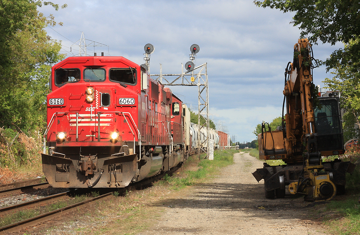 Triclops Soo 6060 and CP 6017 bring this small cut of cars to Lambton yard.