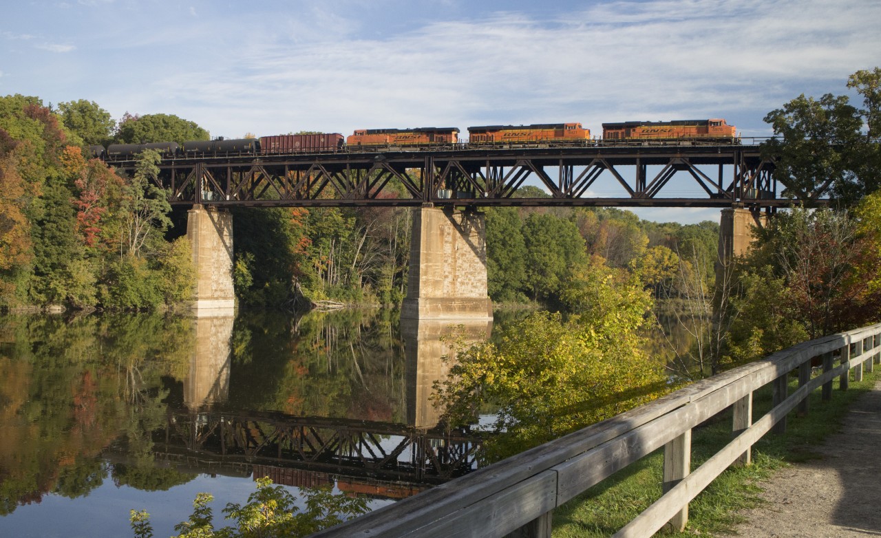 A trio of BNSF units thunder over the Grand River in Paris on a beautiful autumn morning.