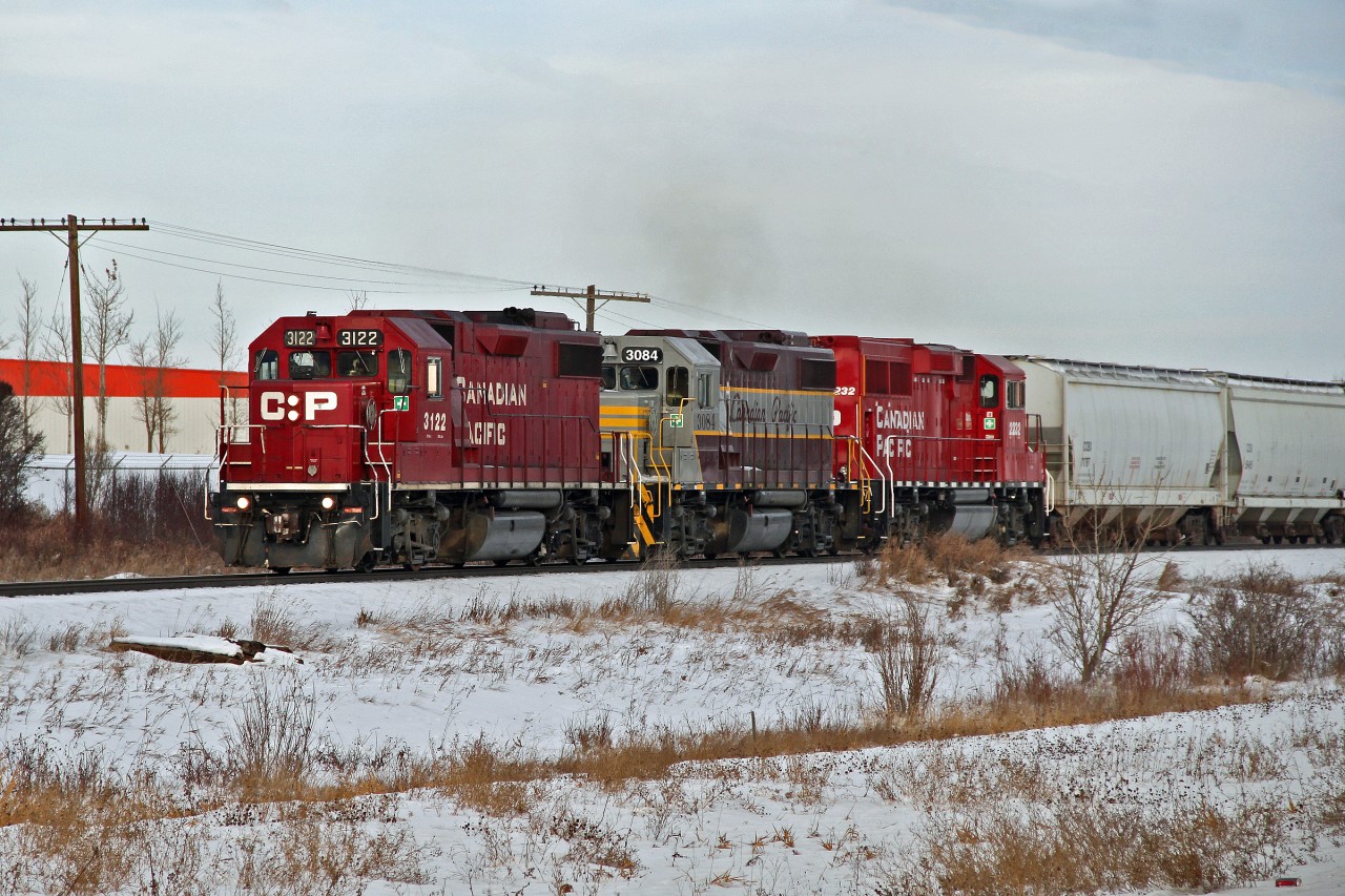 GP 38-2's CP 3122, 3084 in tuscan and grey heritage paint and GP20C-ECO 2232 approaching Red Deer.