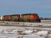A trio of SD40-2(W)'s, CN 5295, 5341 and 5335 approach Scotford Yard on the CN Vegreville Sub with an eastbound train of grain cars and other hoppers.