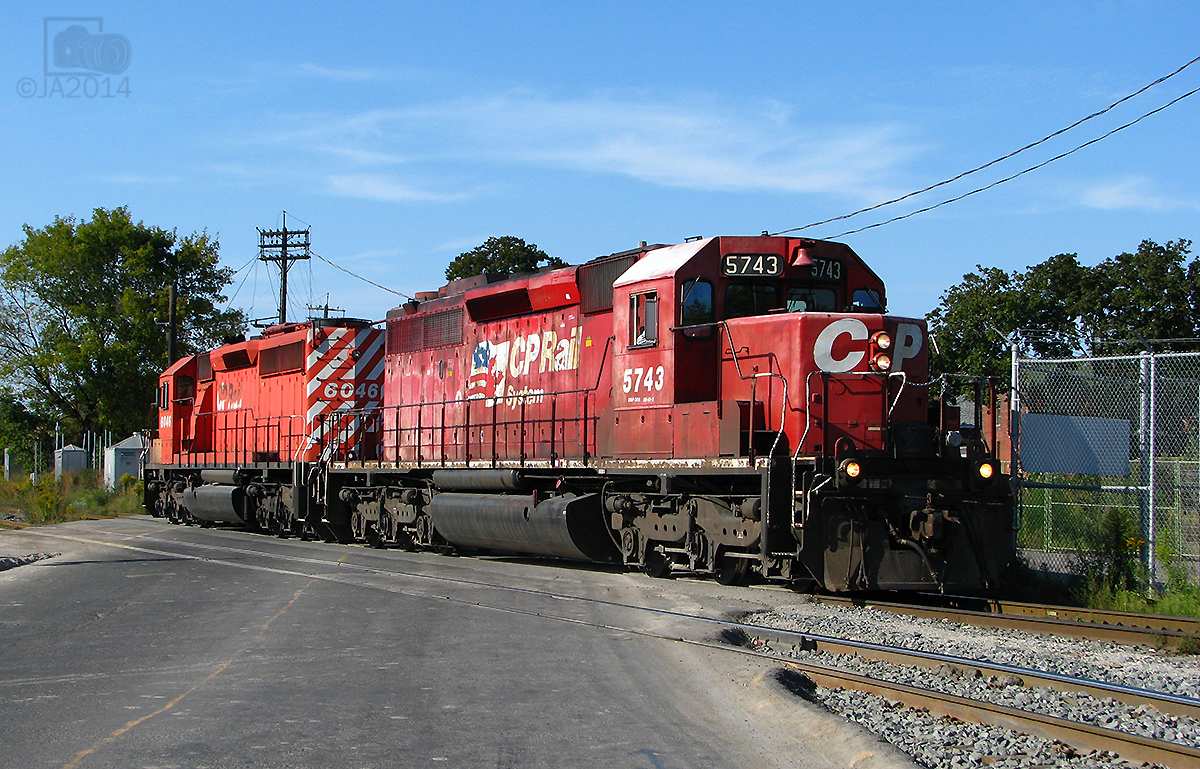 Two different paint schemes, these london built GMD SD40-2 run light power to Toronto yard.