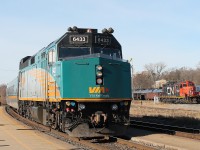 Via 72 arrives at the station stop on a cold Sunday. In the background is the all black yard switcher CN 7000 that had just arrived light engine from the Hagersville sub.