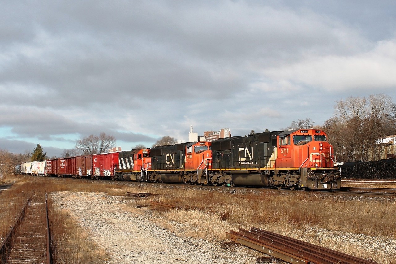 An eastbound mixed freight with a lot of centrebeam cars on a beautiful cold day. CN 5711,5792,7517 lead the train on the south track.