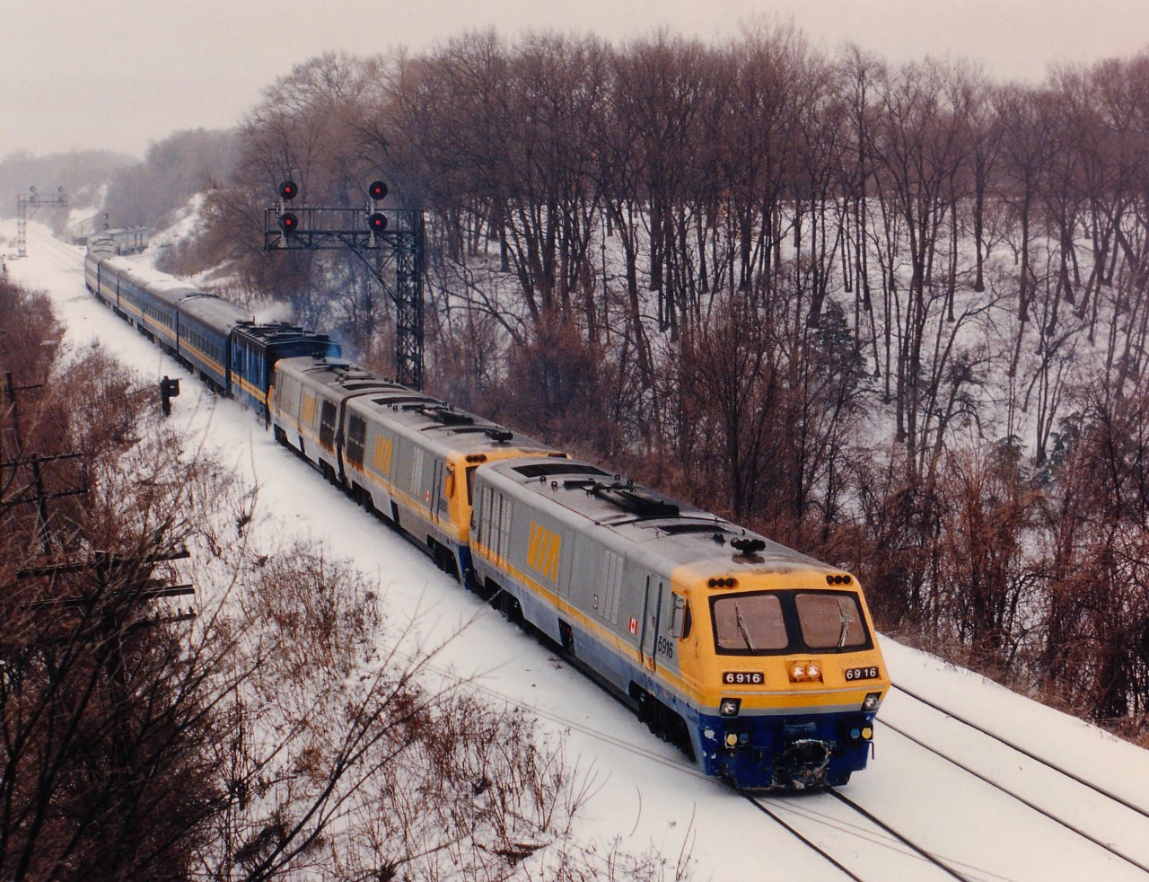 Surprisingly long VIA train #72 about to pass under the railfans Walkbridge at Bayview East with three LRC units, 6916, 6920, 6926 and a steam jenny. Did we have a combination here? Did the earlier #70 die enroute? Never did find out, but it made for a great photo-op.
