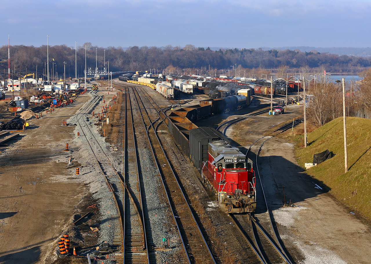 The shortest day of the year finds NECR 3840 switching out cars at the SOR's Stuart Street yard. At left, the track gang is making good progress on the new track and support structures for the new GO Transit Hamilton station and layover yard. Aside from the track, a new signal bridge has been erected along with lights on very tall poles where the old CN shop stood not too long ago.