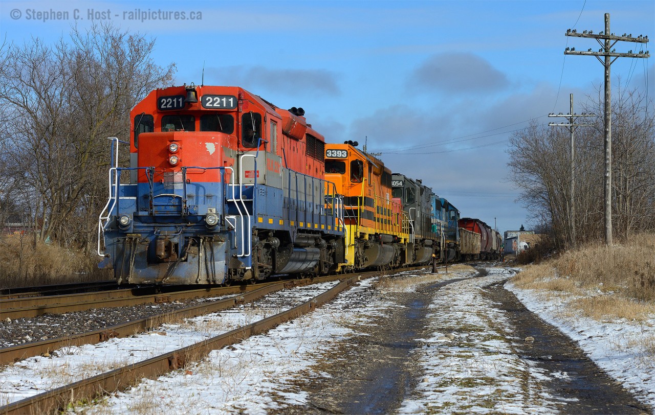 A former CP GP35 RLK2211 is leading train 431 at Guelph, Ontario. A GP35 leading two SD40-2's and aa SD45T-2? Just behind me is train 516 in the clear on the Guelph N Spur lead, XW12 - which I managed to find 4 hours later heading back west. The sun had just come out as 431 approached - a very welcome sight indeed. click here for a photo of 516