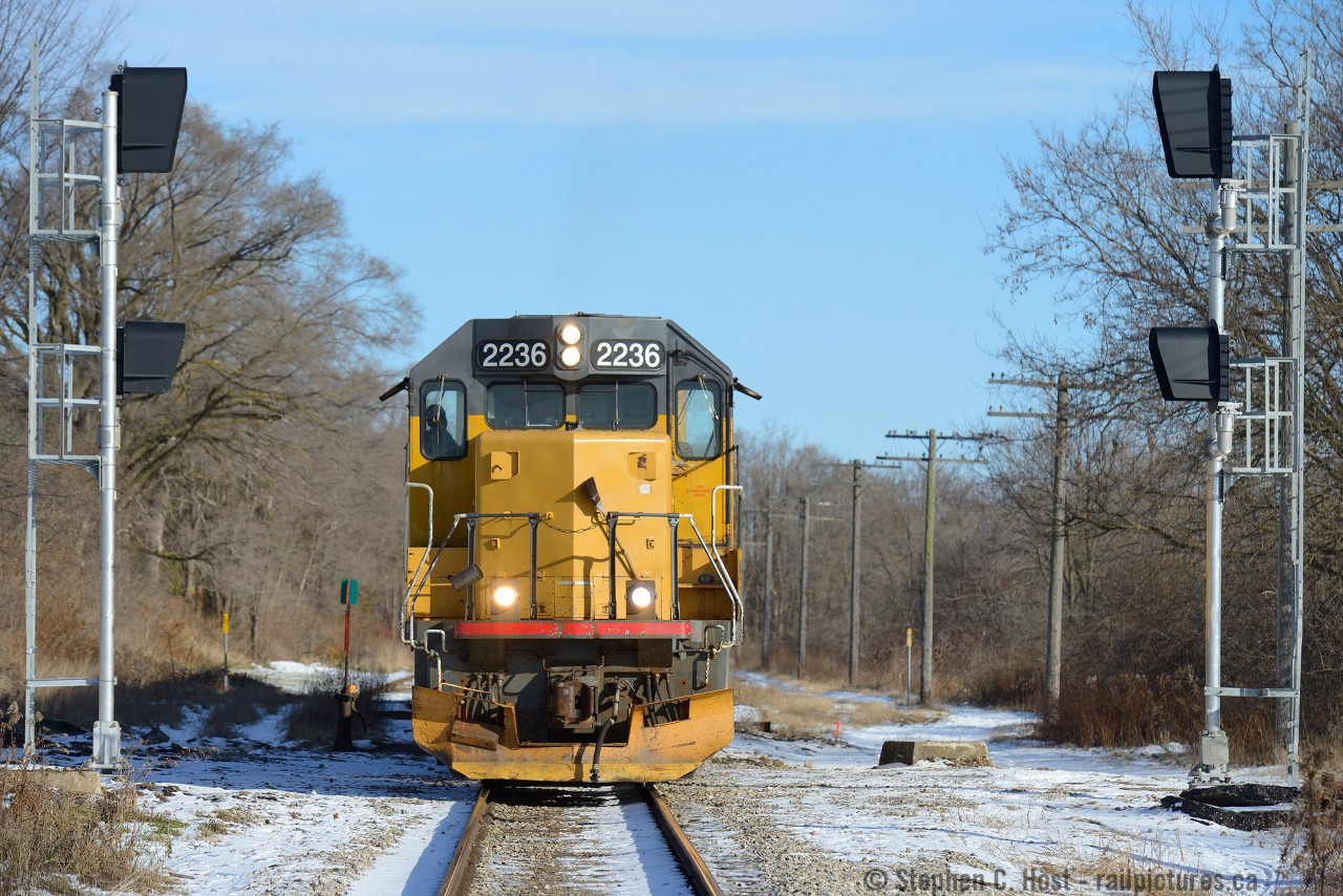 CTC is coming - as evidenced by these signals for the "West Guelph Junction" switch. This area was (and still is) known as (CN) Guelph Junction as a station was located here for the crossing of the Great Western and Grand Trunk railways. The station survived well into the 1970's as an operator would have likely been stationed for the Fergus sub. What Metrolinx will call this new control point is anyone's guess - but I'm hoping Guelph Junction :) .  At the time of this writing this is the newest and most eastward signal on the Guelph sub yet installed.
Operation wise: This is GEXR 582 - now based out of Preston (instead of Kitchener). Engine parks at Eagle St in Preston, runs from Preston to Guelph, sets off empties at the east switch 'Guelph Junction', wyes the engine along Crimea St, and runs to the west switch (pictured here). After lifting cars, train will back along the main (pictured) to the Fergus spur switch for the return to the Galt/Preston area. This seems to occur around Lunchtime.