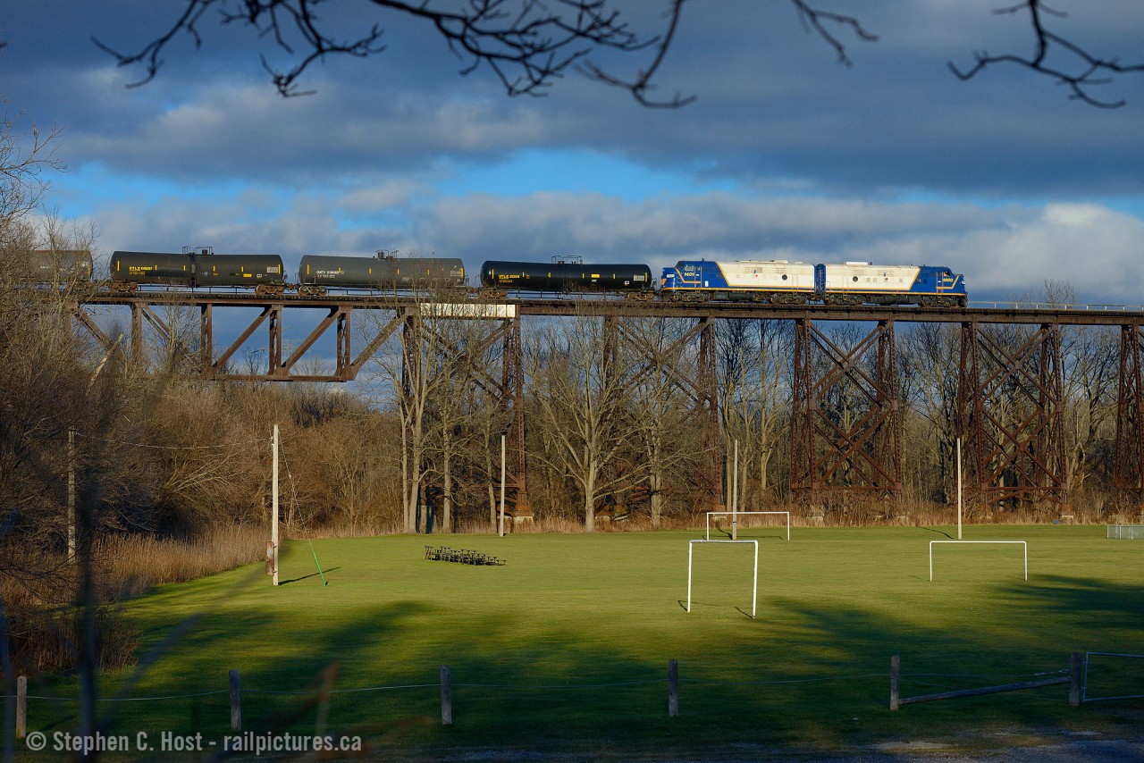Ontario Southland Railway's latest in-service FP9u 1400 is now in the lead paired to sister unit 1401 as they are passing over what the locals call the Wabash Trestle. Crossing over Athletic Park in St. Thomas, Standing here 40+ years ago you would have seen copious amounts of London built  F7's in Wabash (then Norfolk and Western) Service. It's a real treat to have London built F's on the bridge again - only due to the abandonment of the St. Thomas and Eastern Railway last year is this even possible. OSR now handles CN interchange traffic destined for its own customers and Future Transfer in Tillsonburg, and a result OSR runs to the yard in St. Thomas. Sometime soon CN should decide on the future of the Cayuga sub - rumour is a shortline, Railmark, is interested and working on the deal for early 2015 as reported in local newspapers.
Just a few minutes earlier CN 584 cleared the bridge so it was quite busy in St. Thomas this afternoon.
