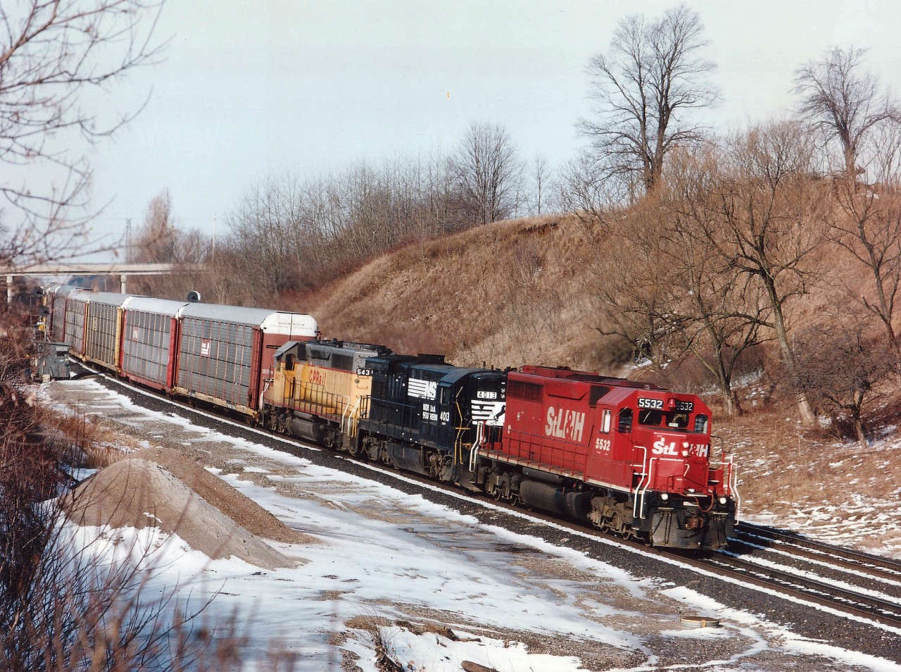 As has been told many times on this site, the NS trains #327 (westward) and the counterpart #328, St. Thomas-Buffalo sported some great combinations of power that made almost every day this train could be observed a real treat. And it even kept regular time!!! At Copetown we see STLH 5532, NS 4013 and CP 5431 on an early March morning, this train usually thru here around 0930. I believe all three units pictured have now been been retired from their respective rosters. Are there any locomotives still around in their ST. Lawrence & Hudson stencils?