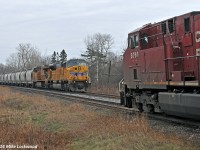 After cooling their heels in the hole for close to two hours, CP 142 finally arrives for a meet with 643 at Spicer. With 124 cars, 643 would not fit into any other siding between here and Toronto other than Oshawa, and the RTC didn't think they'd make Oshawa without delaying 142. With 142 also over siding length, UP 3732 West got to put the newly extended siding here to use. This is the new norm for the Belleville Sub... longer trains and longer delays. 1256hrs.