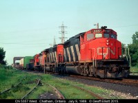 CN 5357 leads Windsor bound train #381 into Chatham on July 9, 1989.  The train will do a setoff and lift in Chatham, then back out of town to just east of the bridge in the background.  Once there, the Operator will line the crossover and the connecting track for 5357 to head south on the CSX Sarnia Subdivision to Fargo where they will swing west through the new connector and onto the CN CASO Subdivision to make their final run to Windsor.