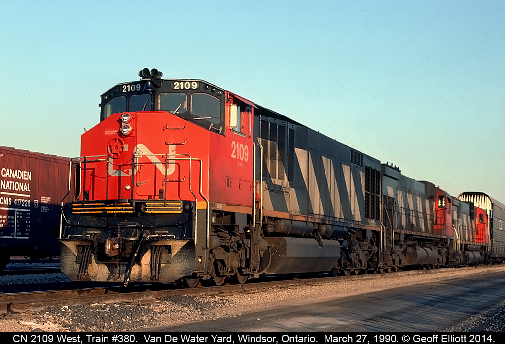 Three "Big 6's", an HR616 #2109, M636, and a C630 round out train #380's consist tonight as they arrive and slowly roll through Van De Water Yard in Windsor, Ontario on March 27, 1990.
