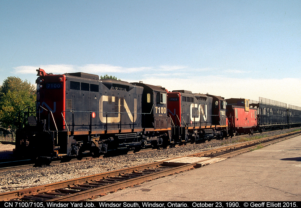 A pair of CN's unique SW1200RSM "Sweeps" has charge of the CN Yard job in Van De Water yard today.  Here the pair, coupled elephant style, have a CN International caboose in tow, along with a long string of empty CN bi-levels as they pull their cut down through the old Electric Yard and in front of Windsor South depot before making a shove back into the yard.