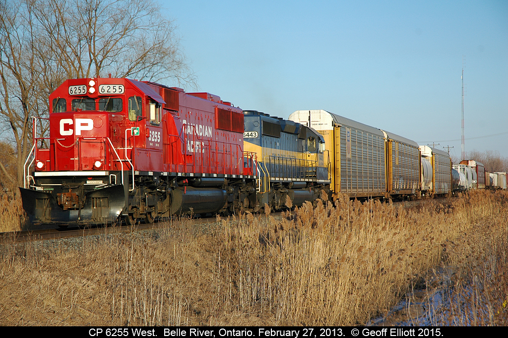 Ex-SOO LINE 6025, now rebuilt to a shimering CP 6225, is teamed up with Iowa, Chicago, and Eastern 6443 as they lead a westbound mixed freight through Belle River, Ontario while enroute to points west.