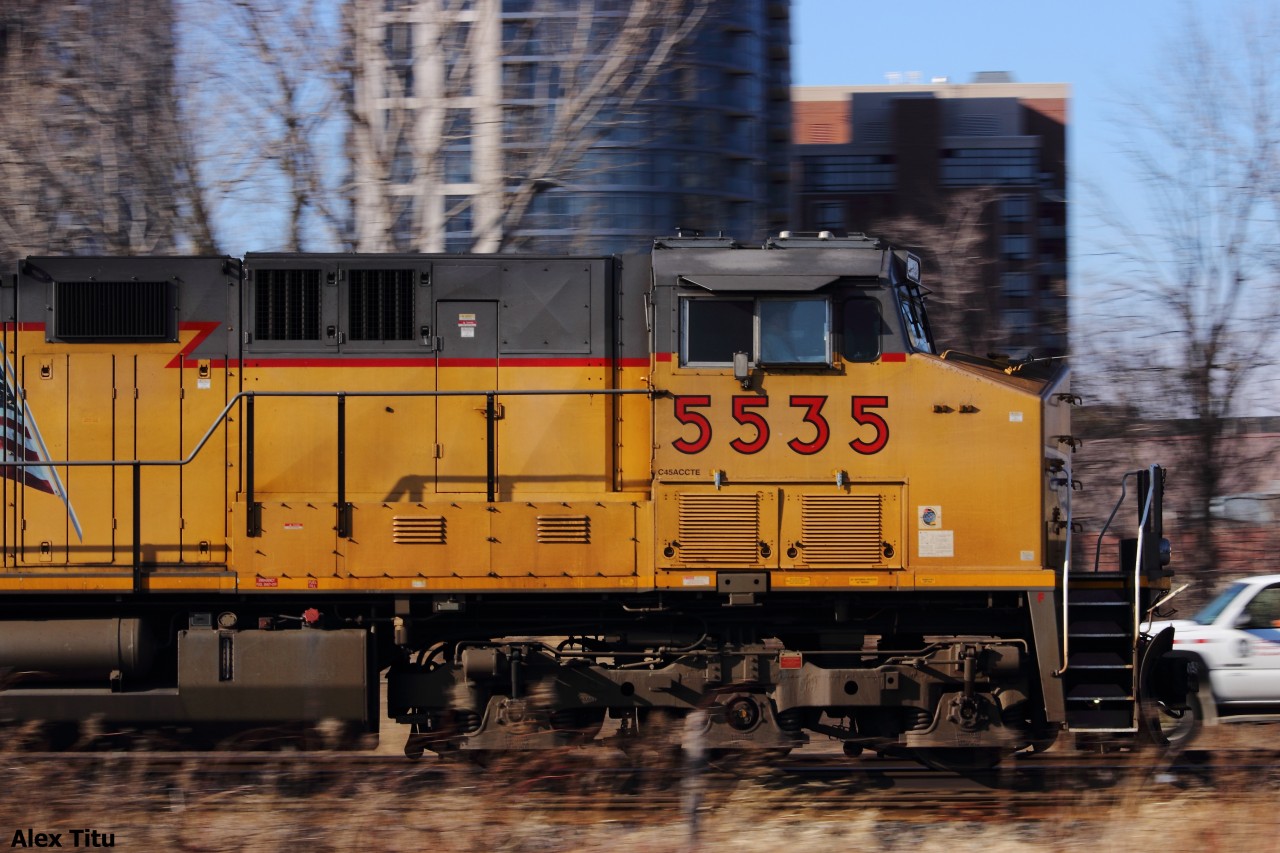 CP 240 with UP 5535 rolls by a foreman's work limits just east of Kipling on the CP Galt Subdivision, pulling a decent amount of autoracks along.